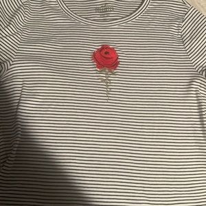 . It’s a size medium, black and white  with a red rose on it ,